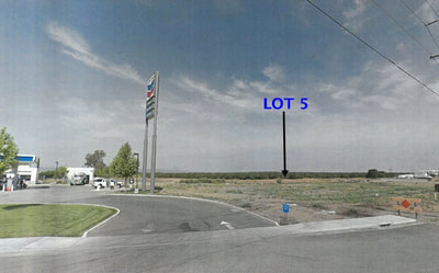 A google street view image of a lot with a blue sign.