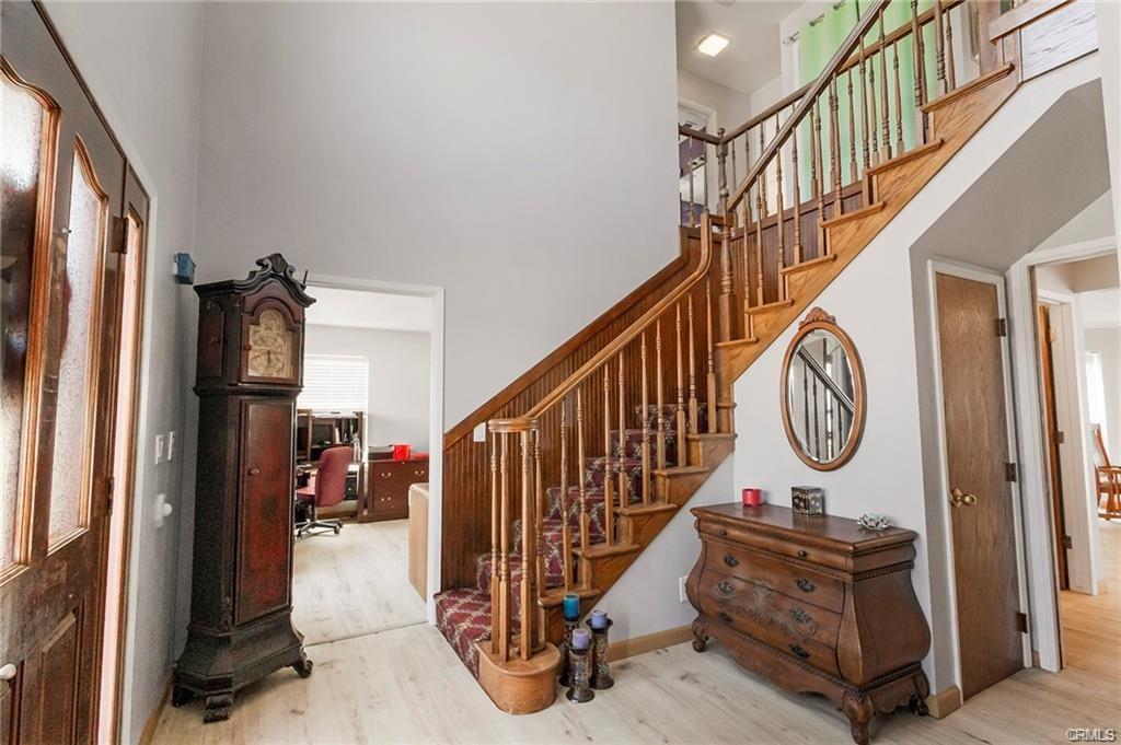 large wooden staircase, upstairs hall, and view into home office