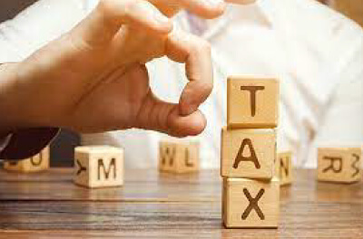 Image of letter blocks in a stack that say "Tax"